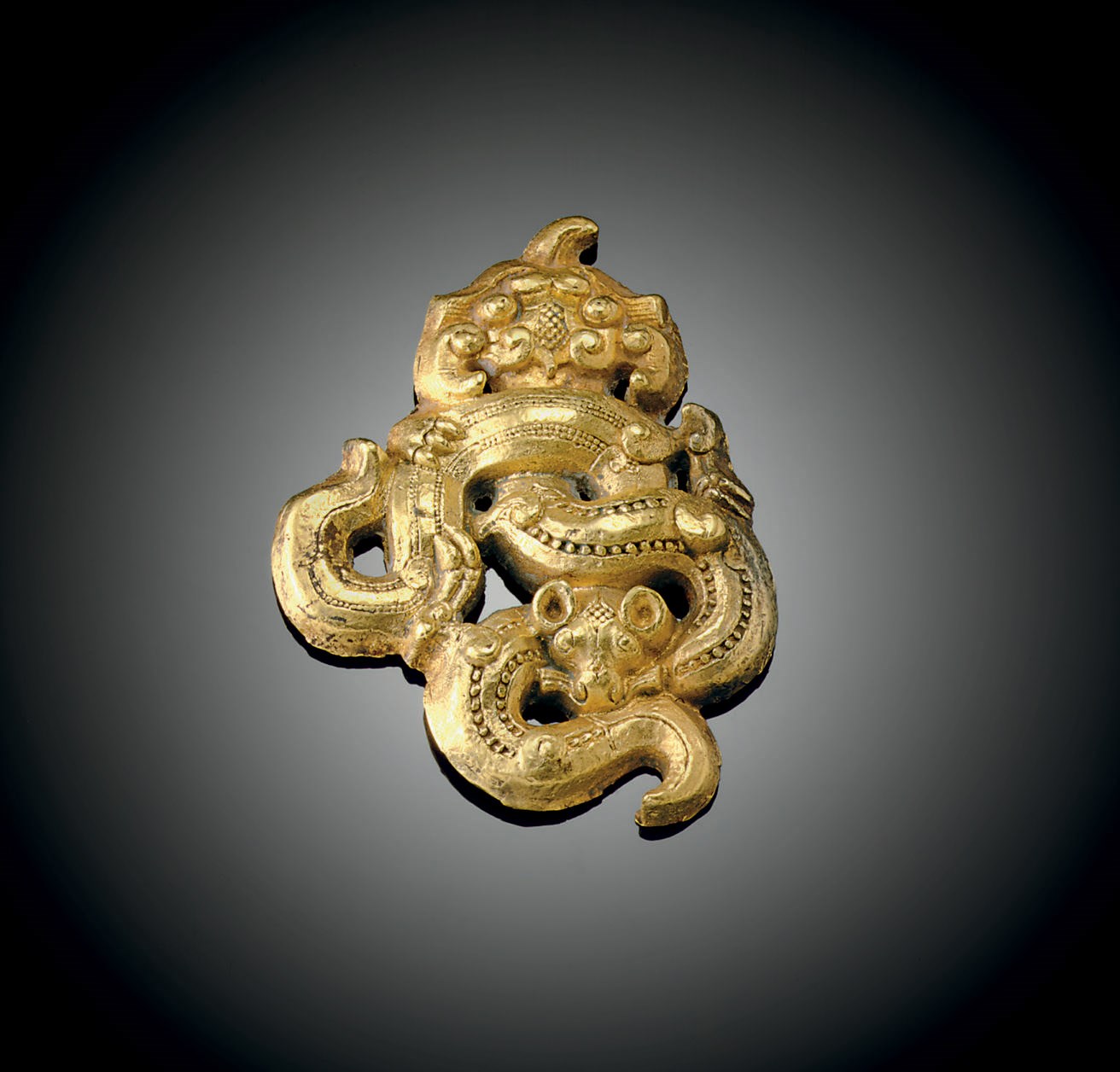 A RARE SMALL GOLD OPENWORK ORNAMENT