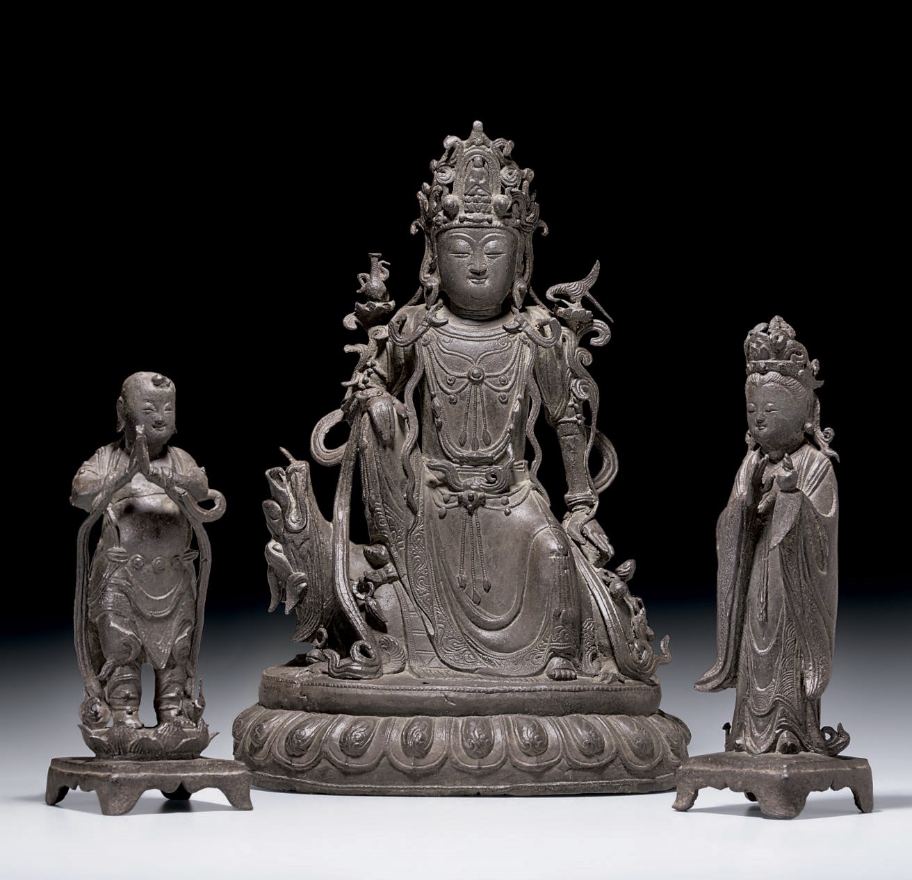A RARE BRONZE GROUP OF GUANYIN, LONG NU AND SHAN CAI