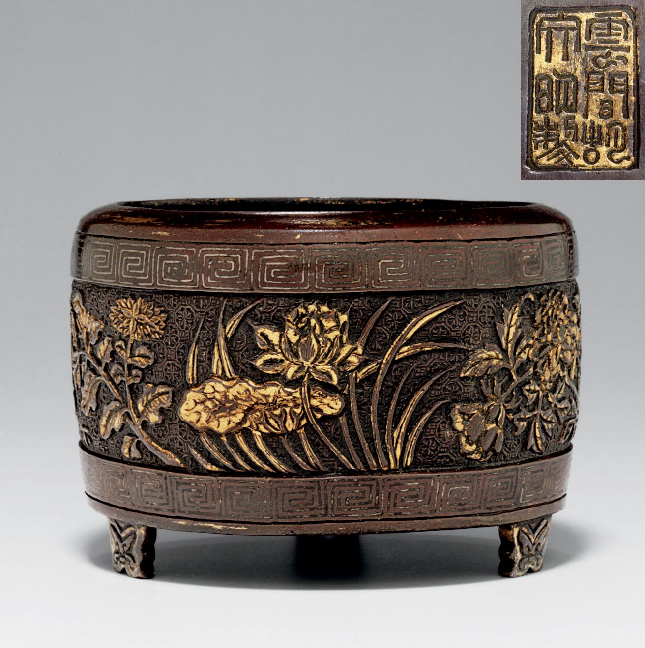 A PARCEL-GILT BRONZE TRIPOD CENSER