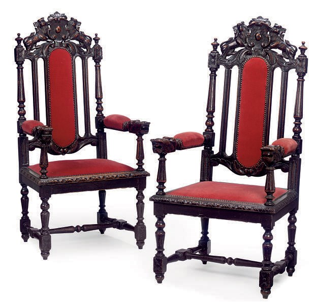 A PAIR OF NORTH EUROPEAN CARVED OAK OPEN ARMCHAIRS