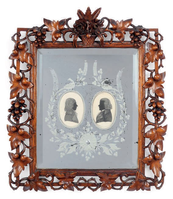 A CONTINENTAL CARVED WOOD MIRRORED-BACK FRAME
