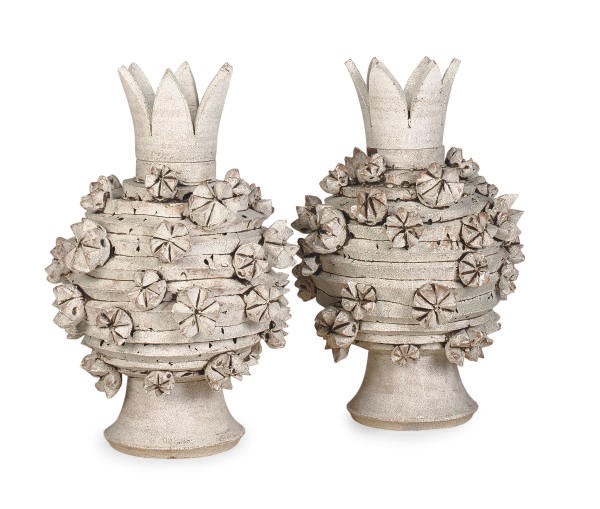 A PAIR OF GLAZED EARTHENWARE PINEAPPLE FORM VASES AND COVERS,