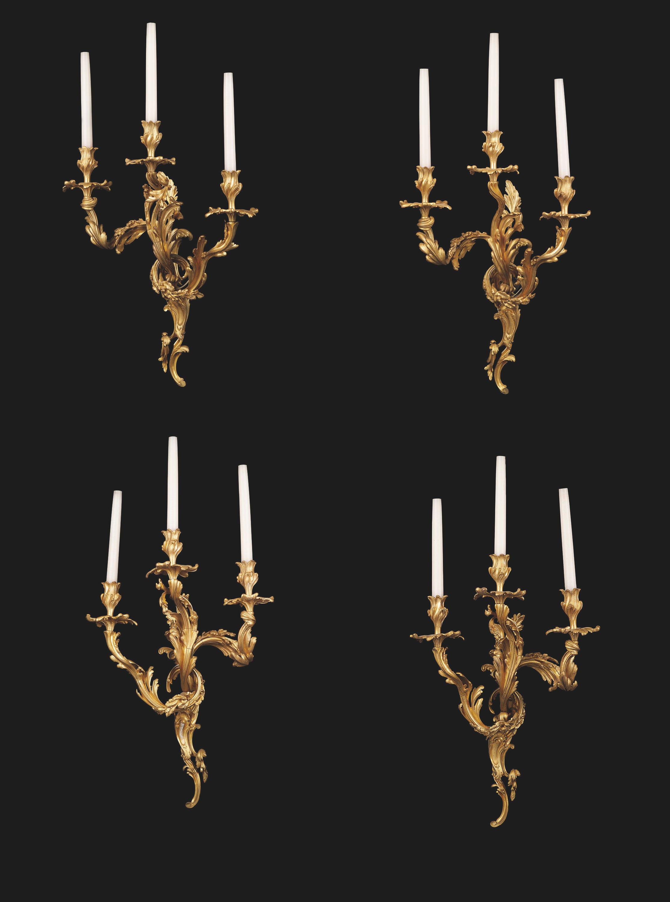 A SET OF FOUR FRENCH GILT-BRONZE THREE-BRANCH WALL-LIGHTS OF LOUIS XV STYLE