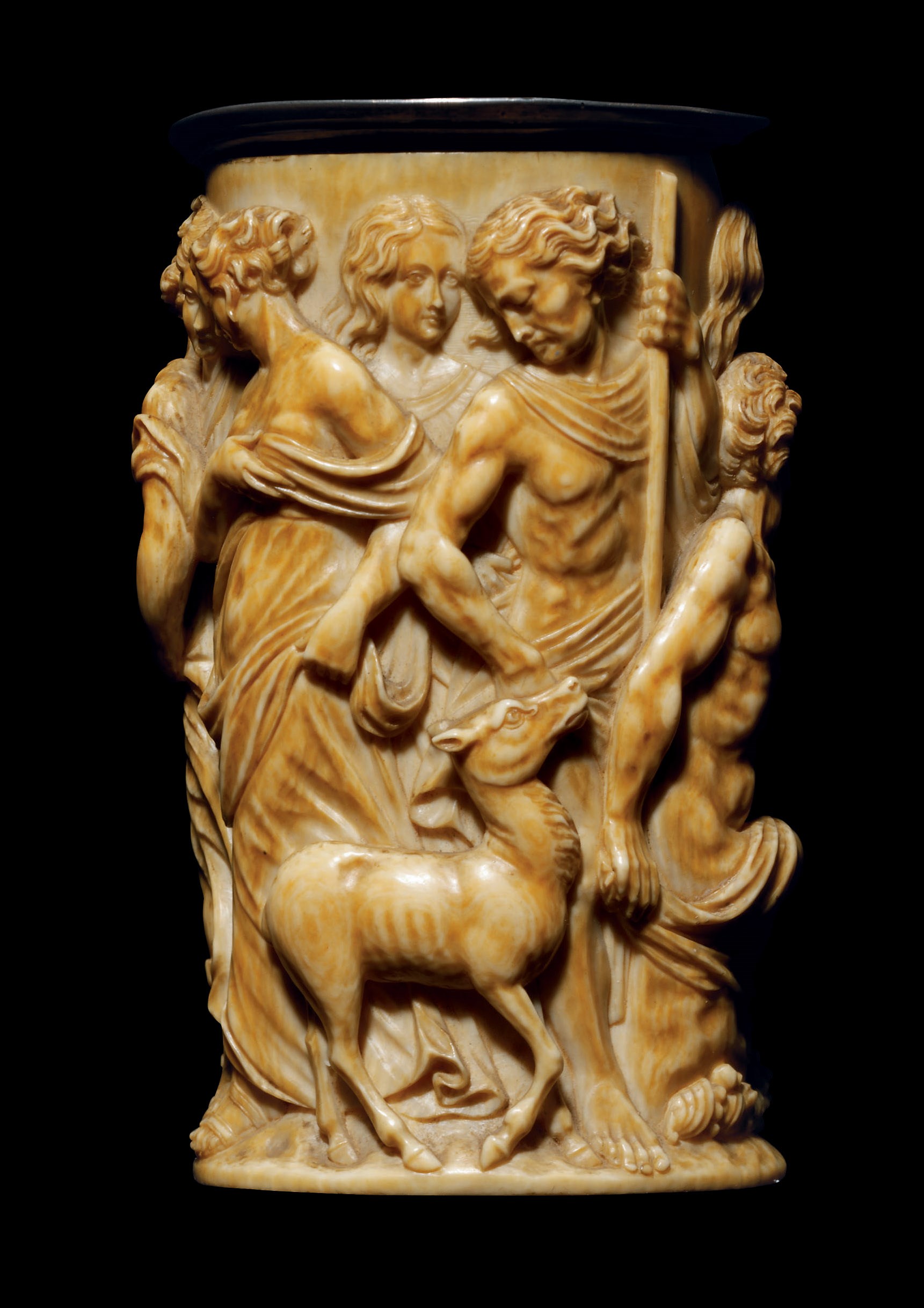 A CYLINDRICAL CARVED IVORY BEAKER DEPICTING ATALANTA AND MELEAGER