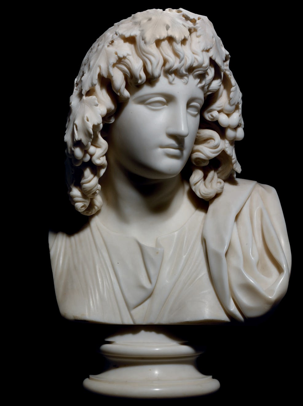 A CARVED MARBLE BUST OF MELPOMENE