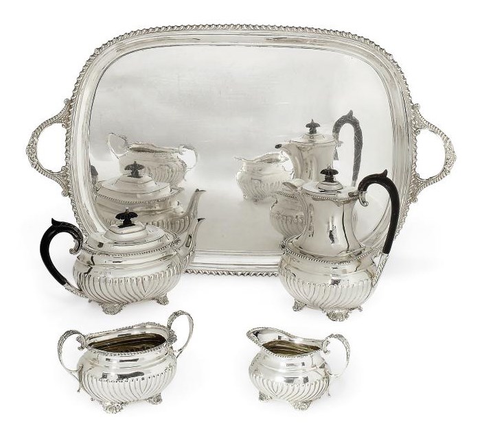 A LATE VICTORIAN SCOTTISH FOUR-PIECE SILVER TEA SERVICE WITH TRAY EN SUITE