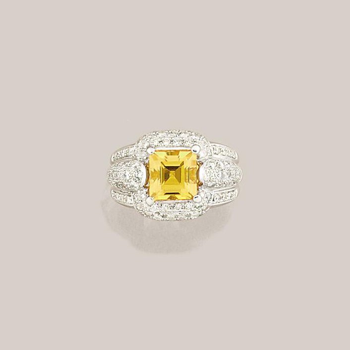 A yellow sapphire and diamond cluster ring