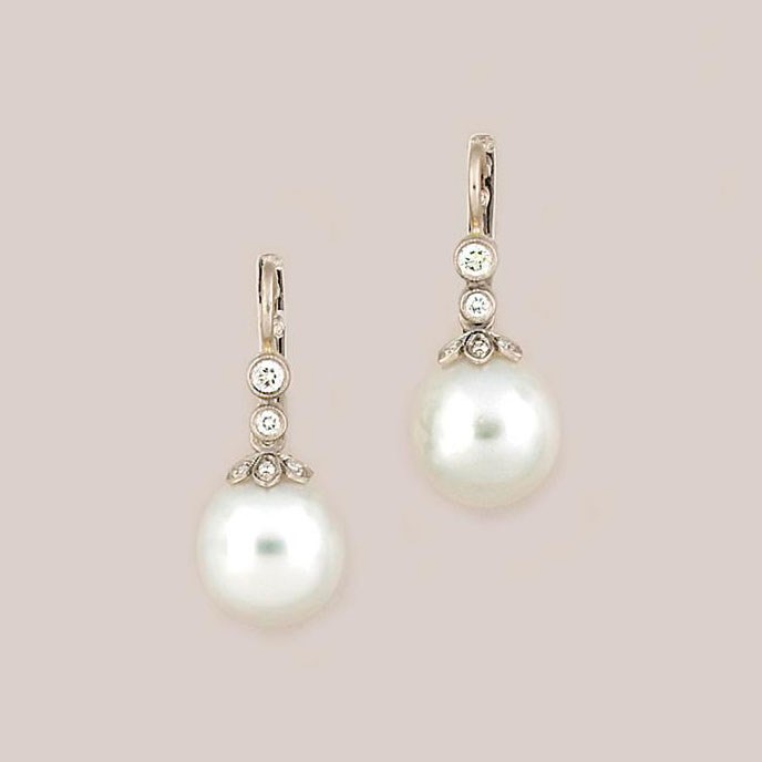 A pair of cultured pearl and diamond earrings