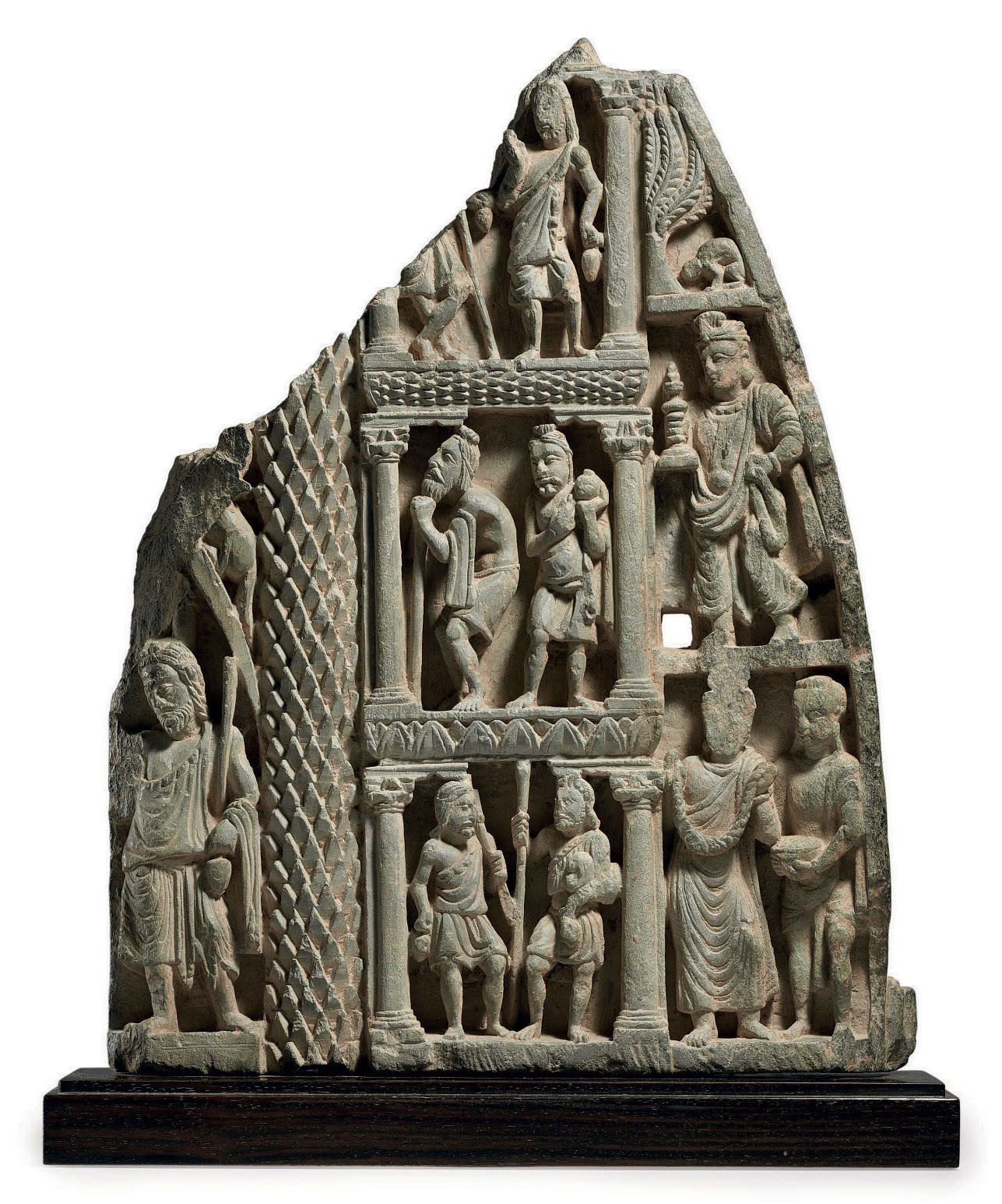 A gray schist relief with attendant figures