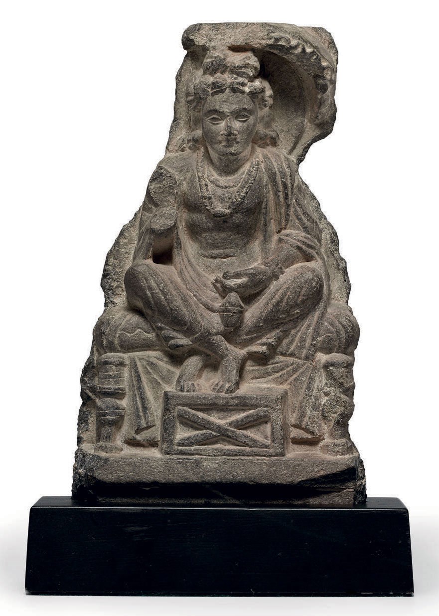 A small gray schist figure of Maitreya
