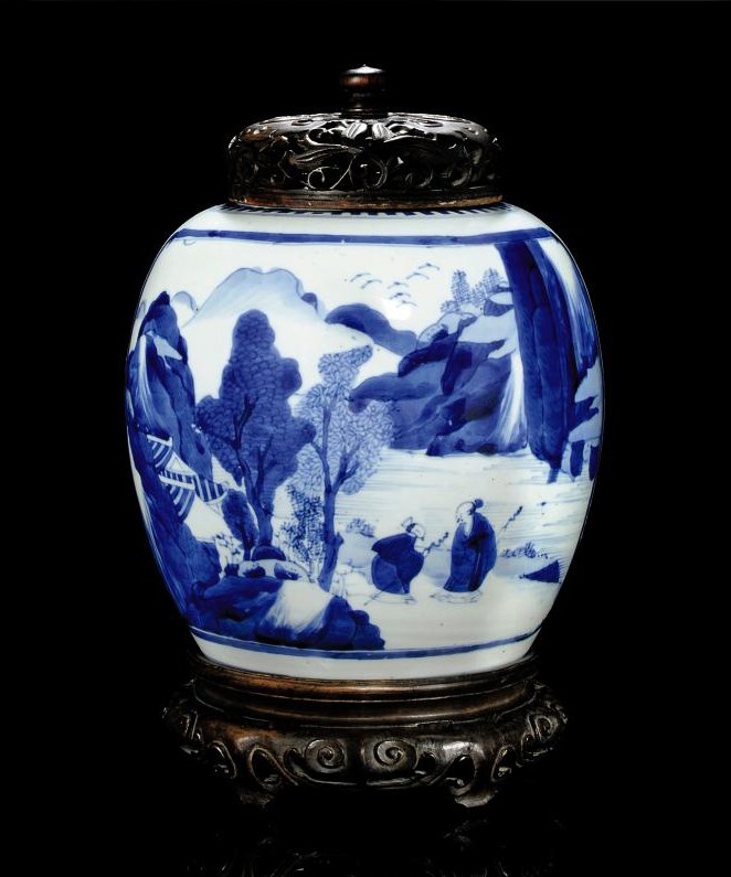 A BLUE AND WHITE JAR WITH WOODEN COVER AND STAND