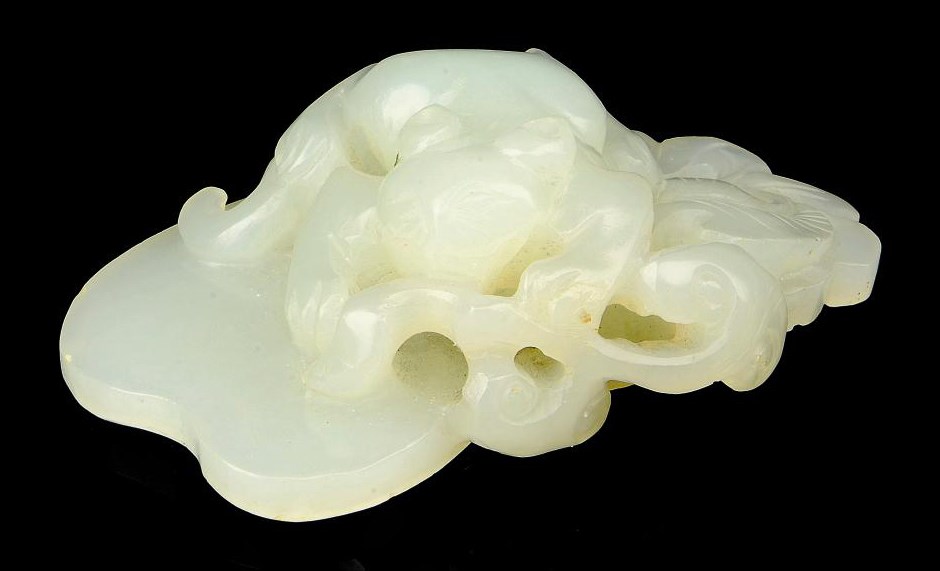 A PALE CELADON JADE CAT CARVING
