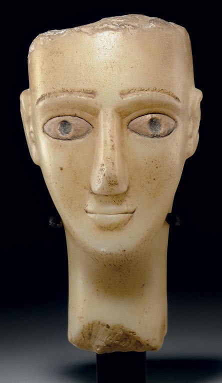 A SOUTH ARABIAN ALABASTER HEAD OF A MAN