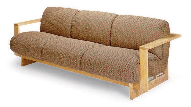 A LIMED-OAK AND UPHOLSTERED 'CUBIST' THREE-SEAT SOFA,