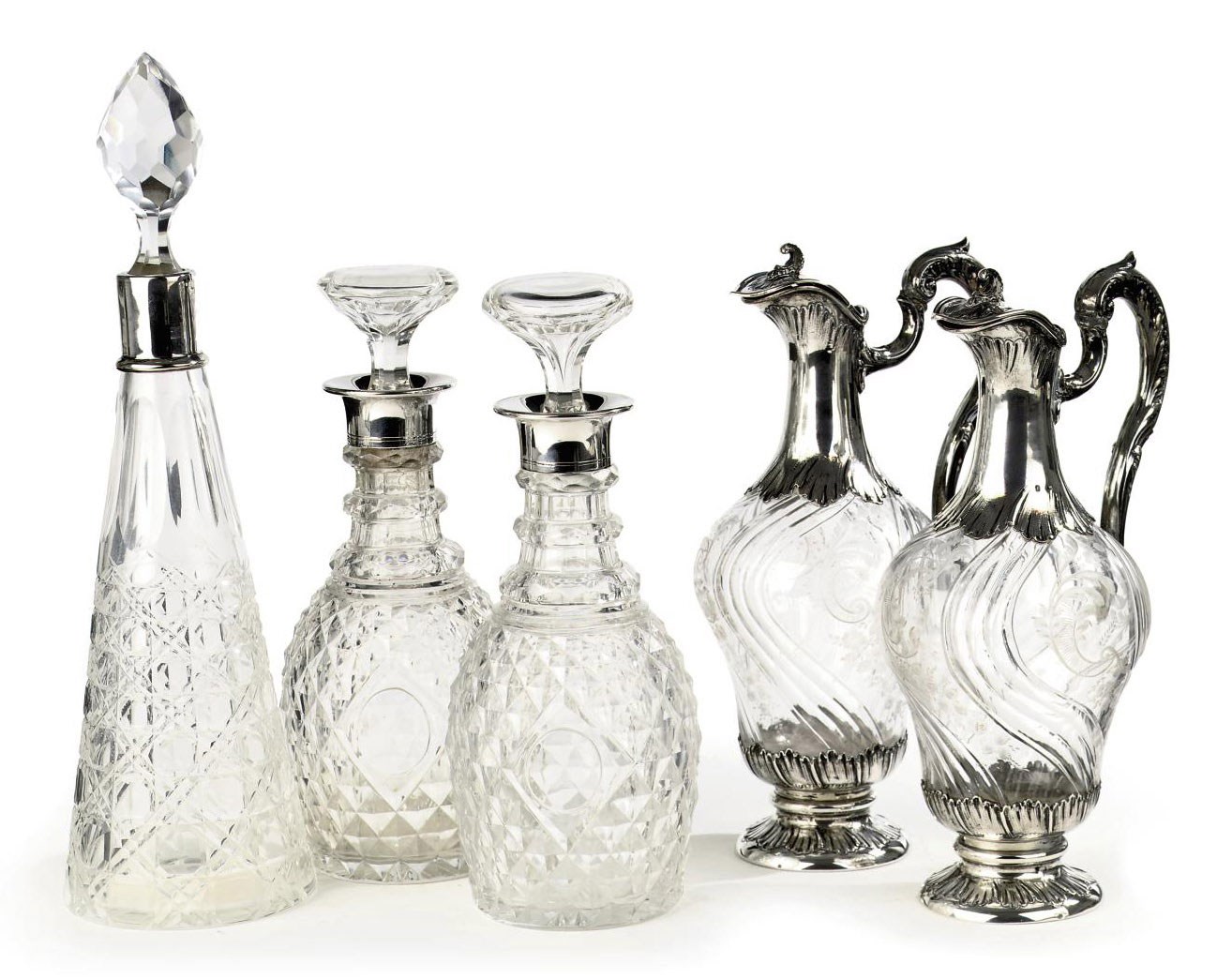 A pair of French silver-mounted glass claret jugs, a pair of silver-mounted flasks and a silver-mounted flask