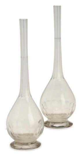A PAIR OF CUT GLASS FOOTED BOTTLES,