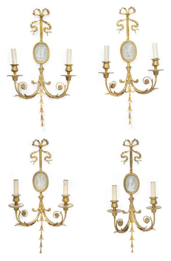 A SET OF FOUR GILT-BRASS TWIN-LIGHT WALL APPLIQUES