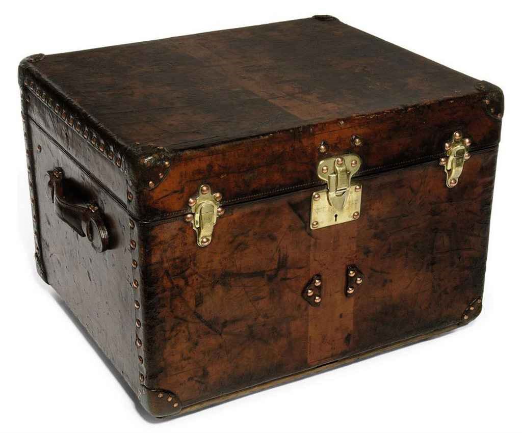 A SMALL TRUNK IN NATURAL COW HIDE