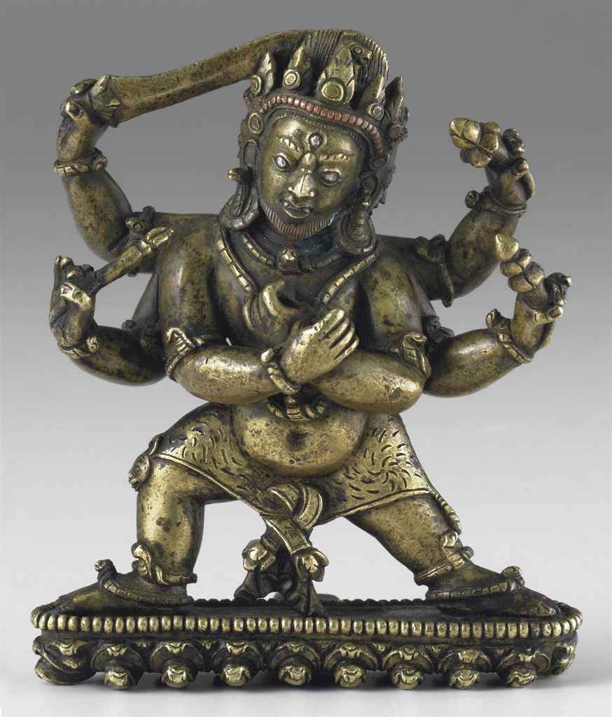 A silver-inlaid bronze figure of a protector deity