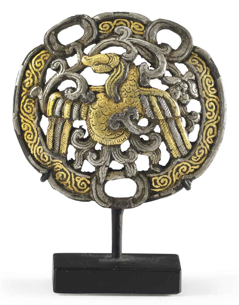 A gold and silver damascened iron horse fitting
