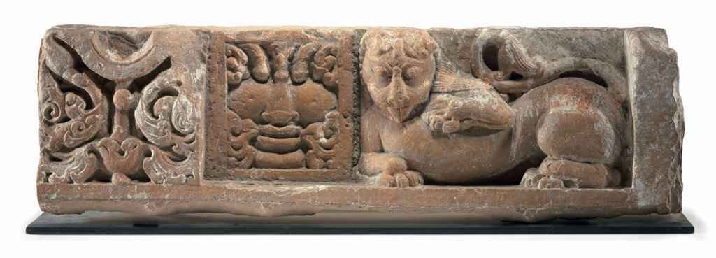 A red sandstone relief with lion