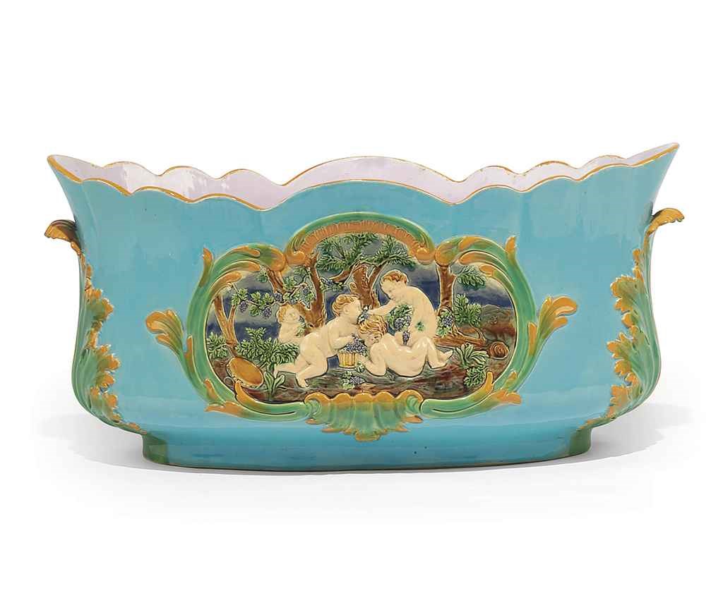A MINTON MAJOLICA TURQUOISE-GROUND SHAPED-OVAL JARDINIERE