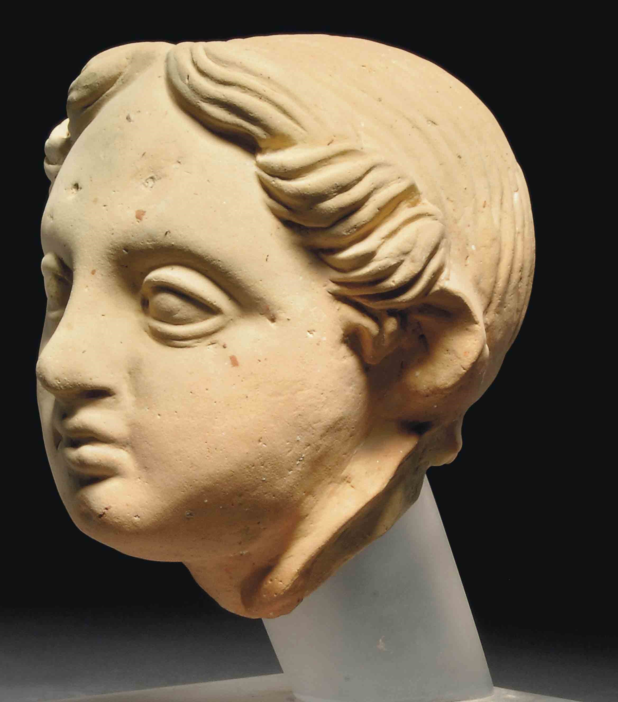 AN ETRUSCAN TERRACOTTA HEAD OF A BOY