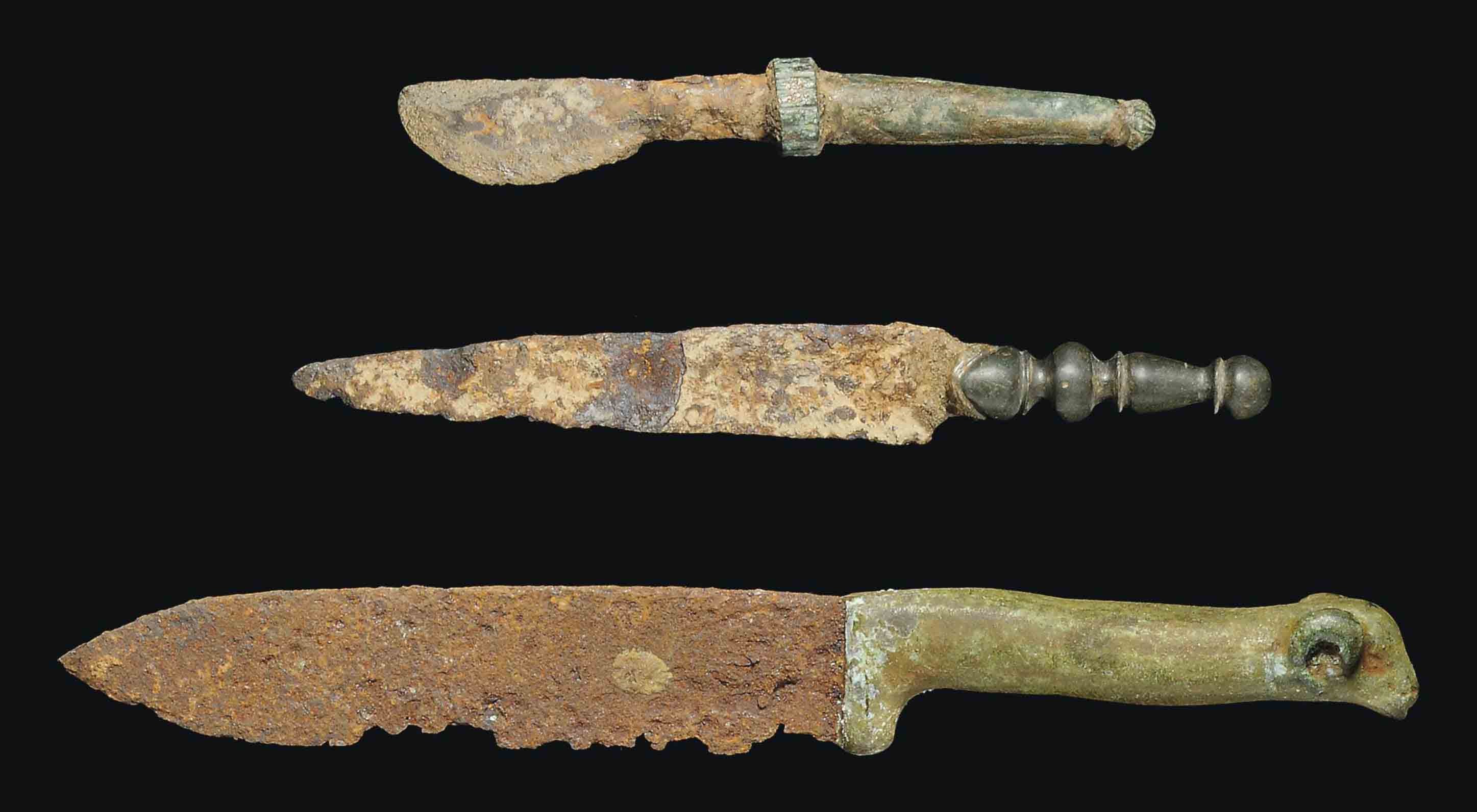 THREE ROMAN BRONZE AND IRON KNIVES