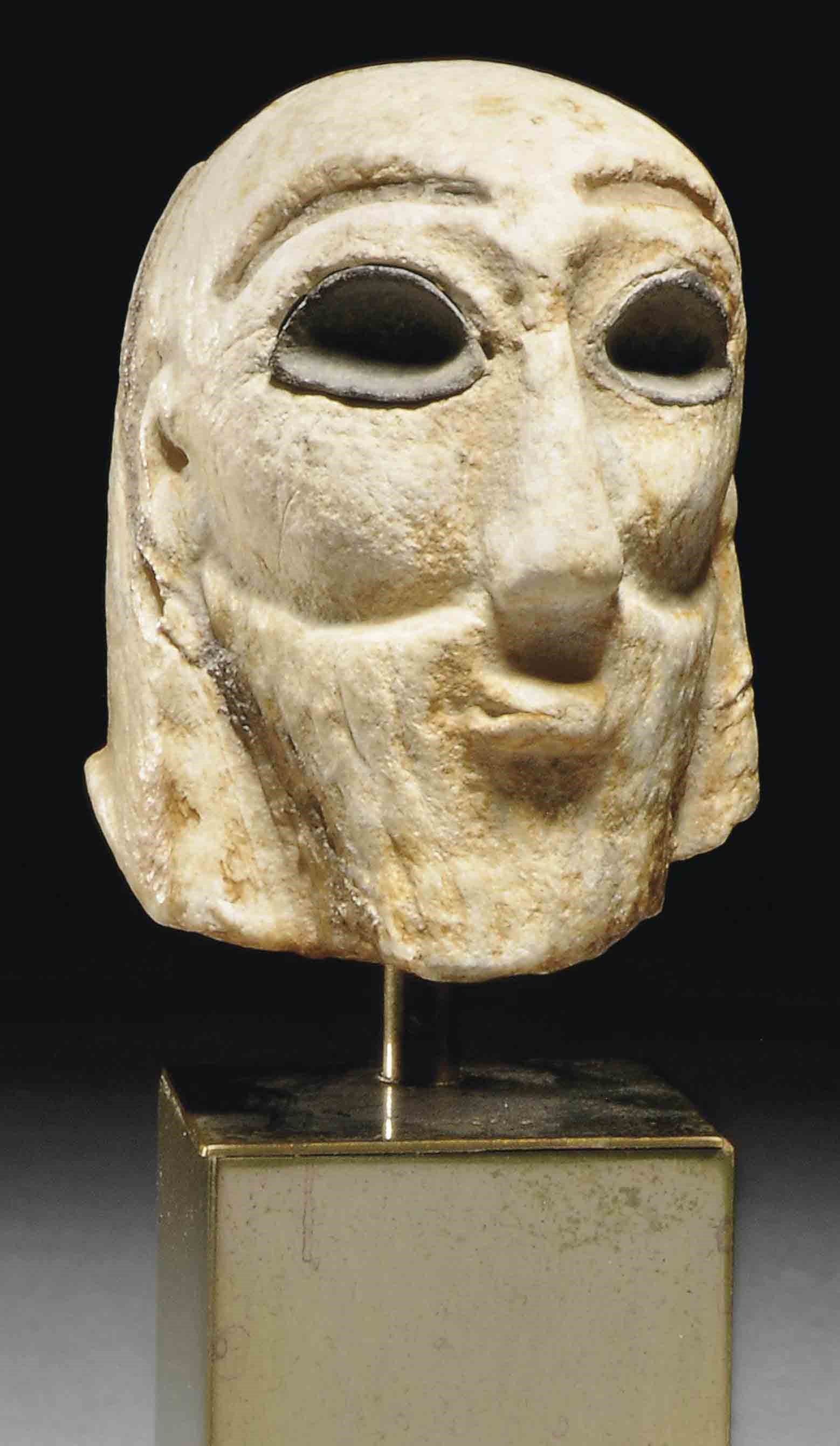 A MESOPOTAMIAN GYPSUM HEAD OF A WORSHIPPER