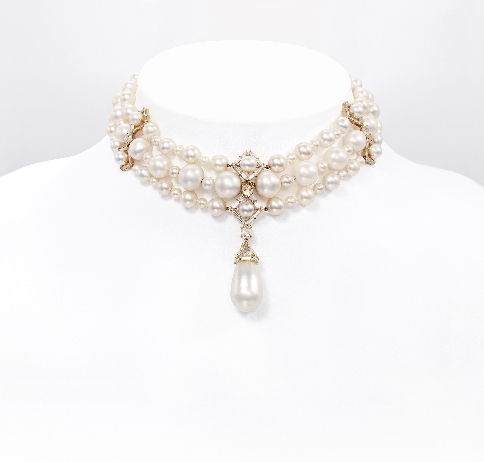 AN ATTRACTIVE THREE-STRAND NATURAL PEARL AND DIAMOND NECKLACE