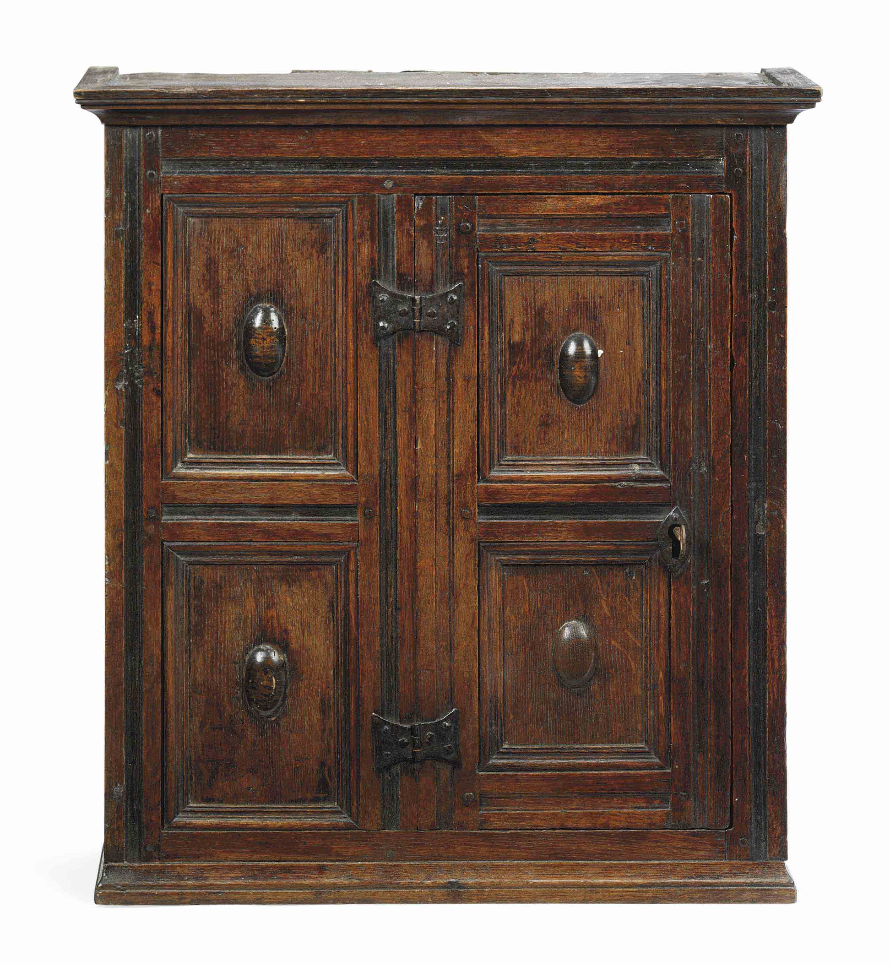 A NORTH EUROPEAN OAK AND EBONISED CUPBOARD