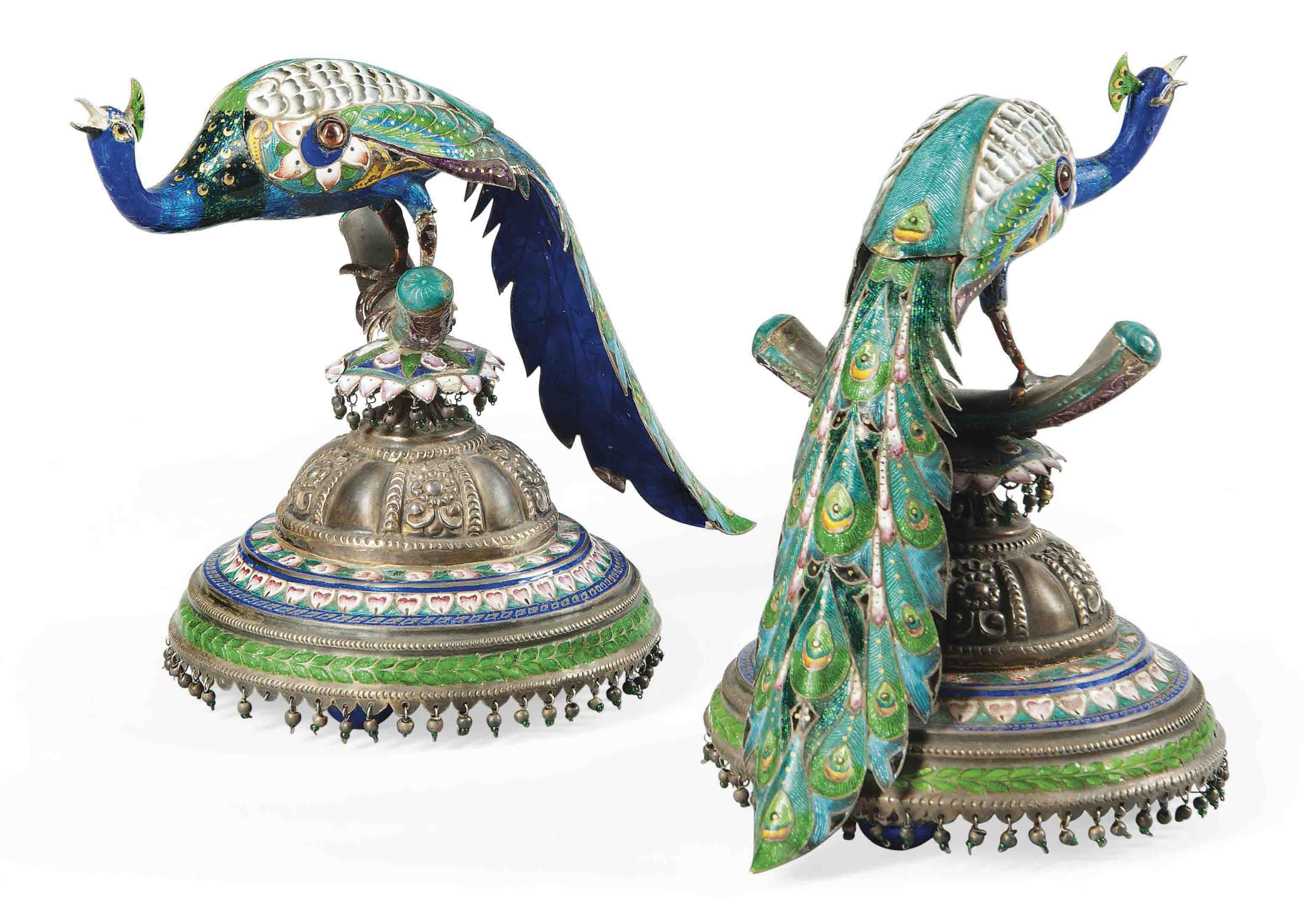 A PAIR OF BENARES PARCEL-GILT SILVER ENAMELLED PEACOCKS ON STANDS