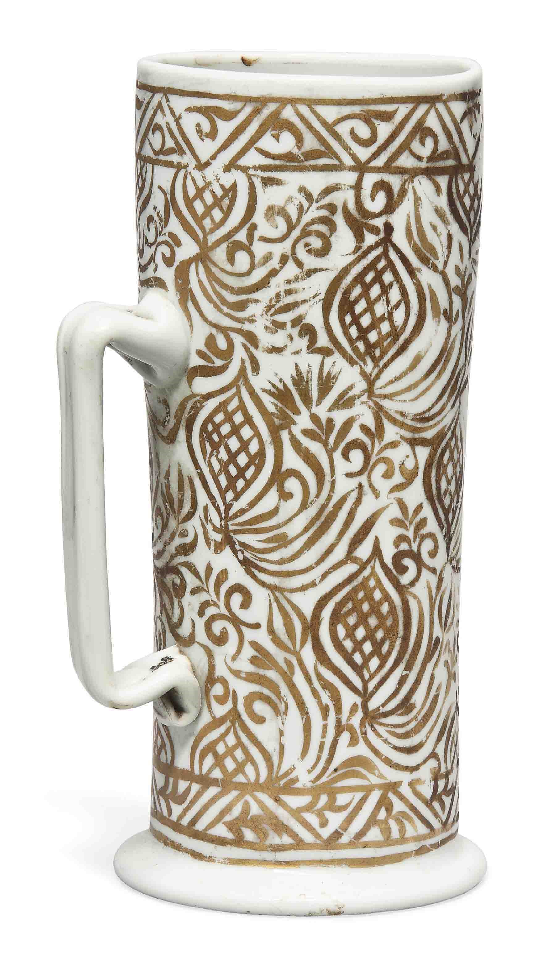 A GILT OPAQUE WHITE GLASS TANKARD