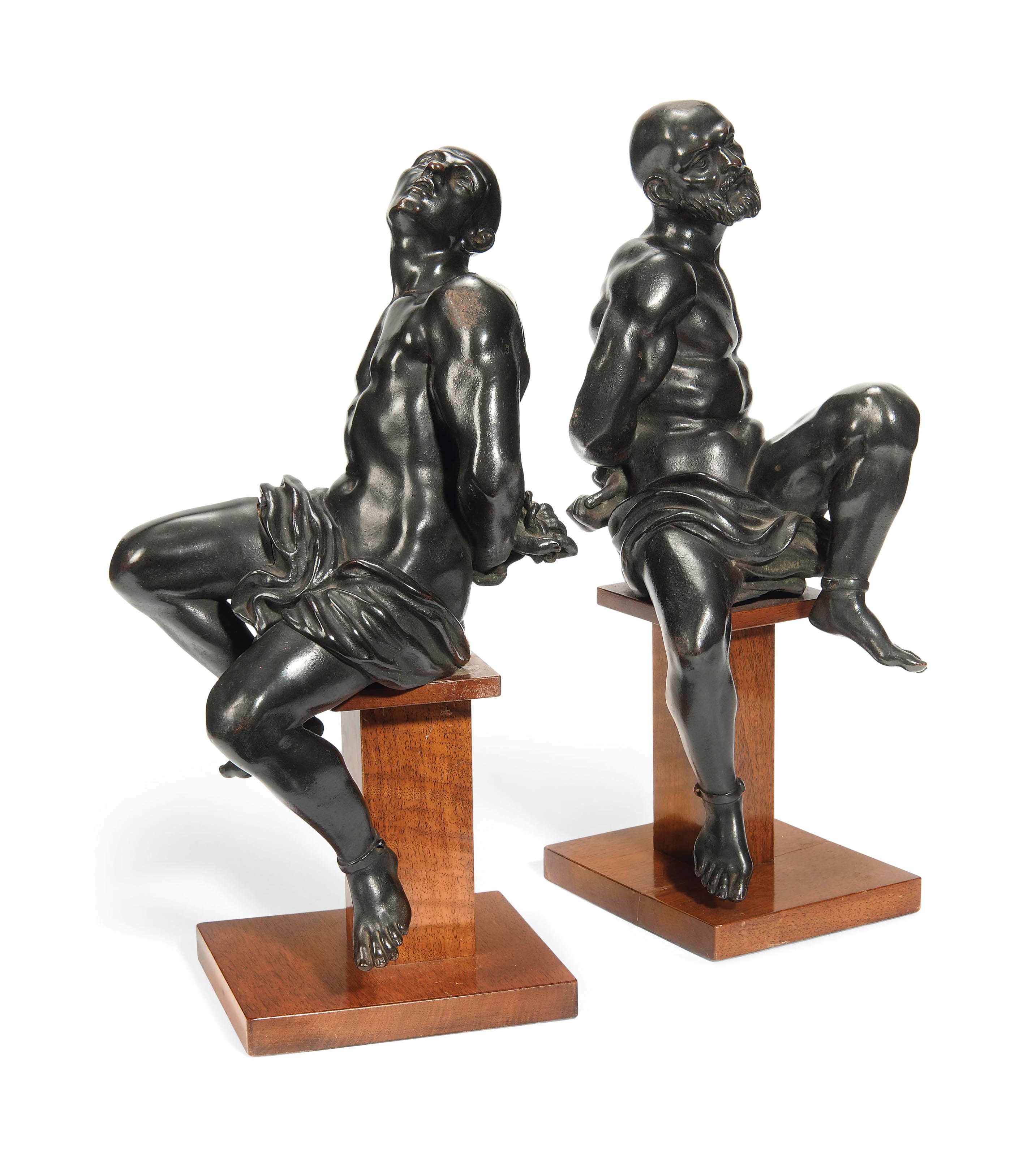 A PAIR OF BRONZE MODELS OF SLAVES