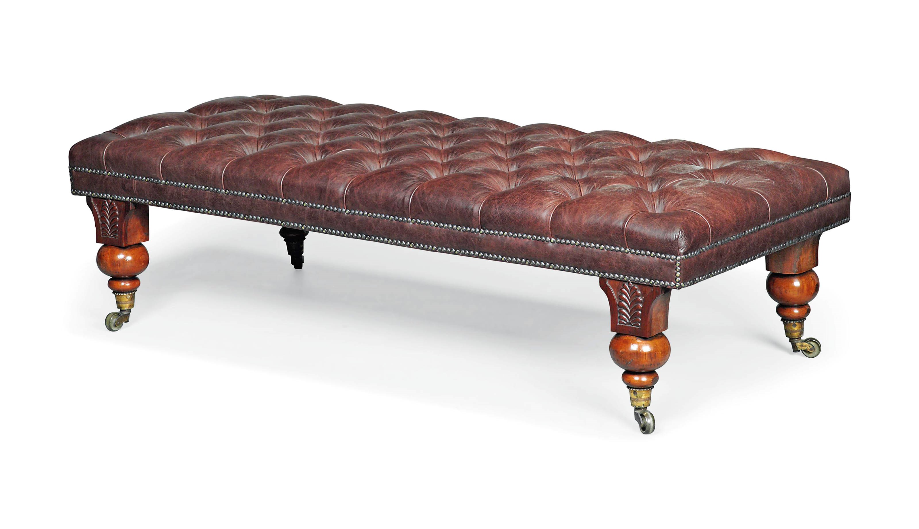 A MAHOGANY AND BUTTONED LEATHER LONG STOOL
