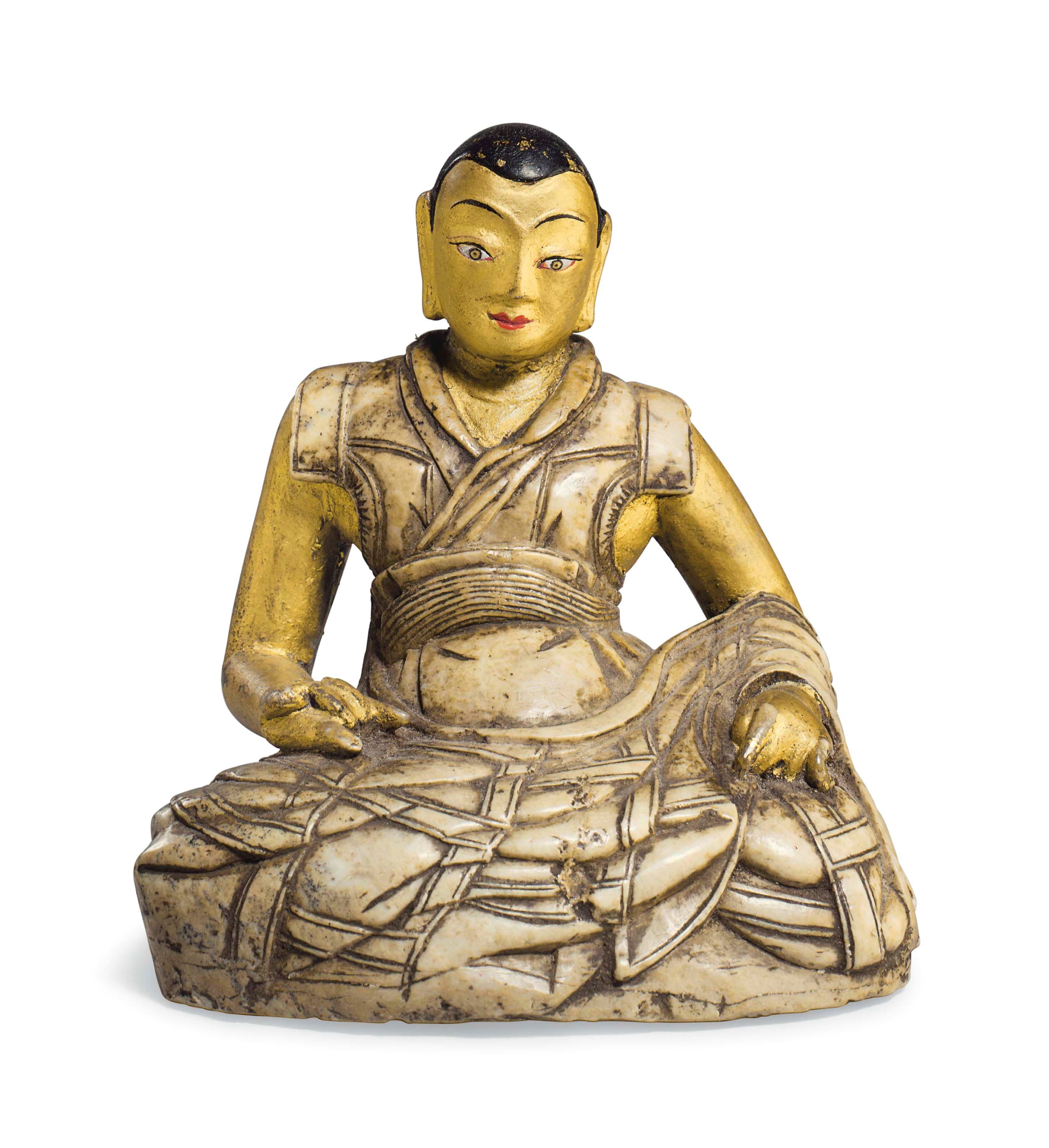 A gilt and polychromed soapstone figure of a Lama
