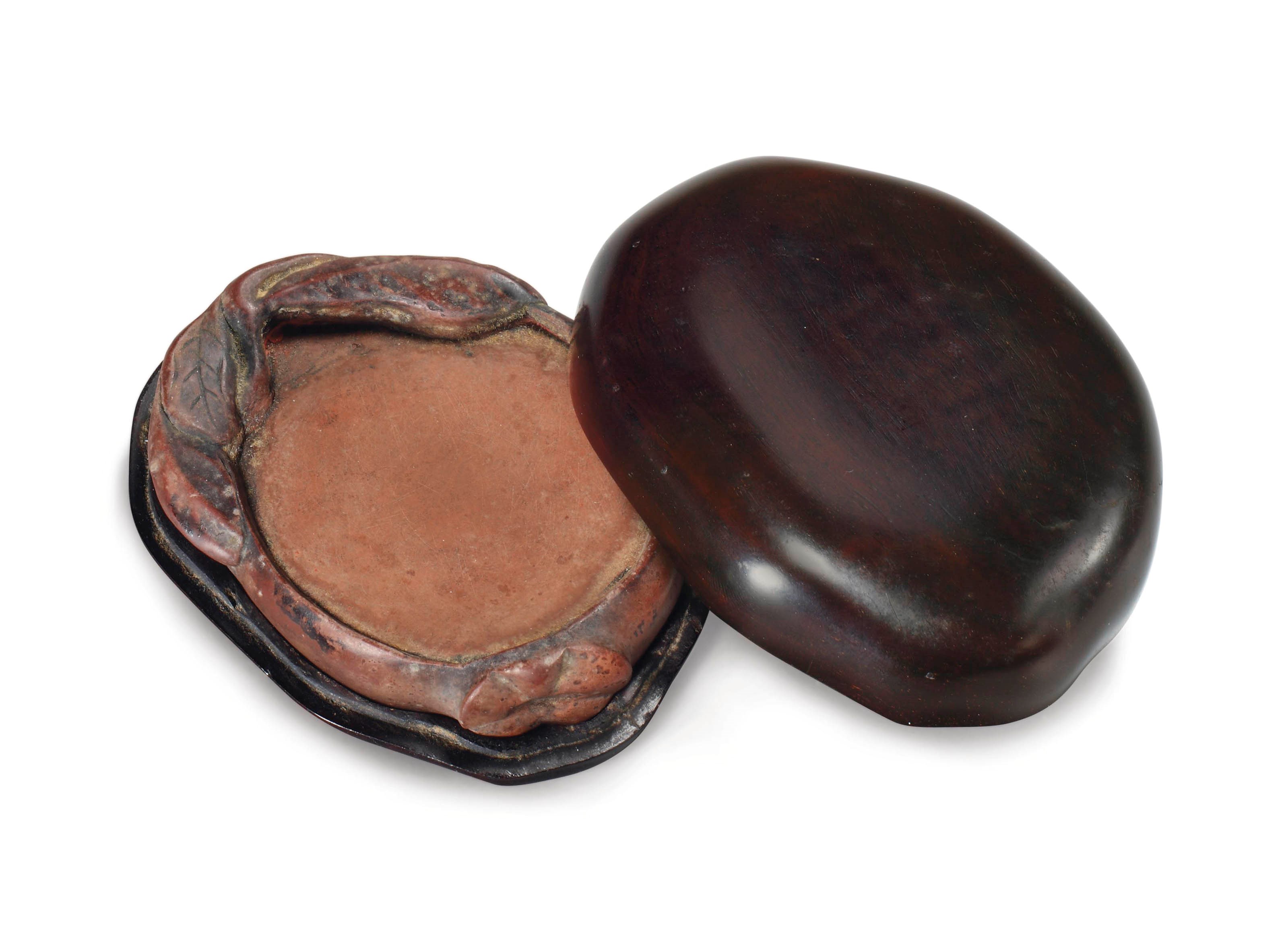 A RARE SMALL CHENGNI POMEGRANATE-FORM INKSTONE