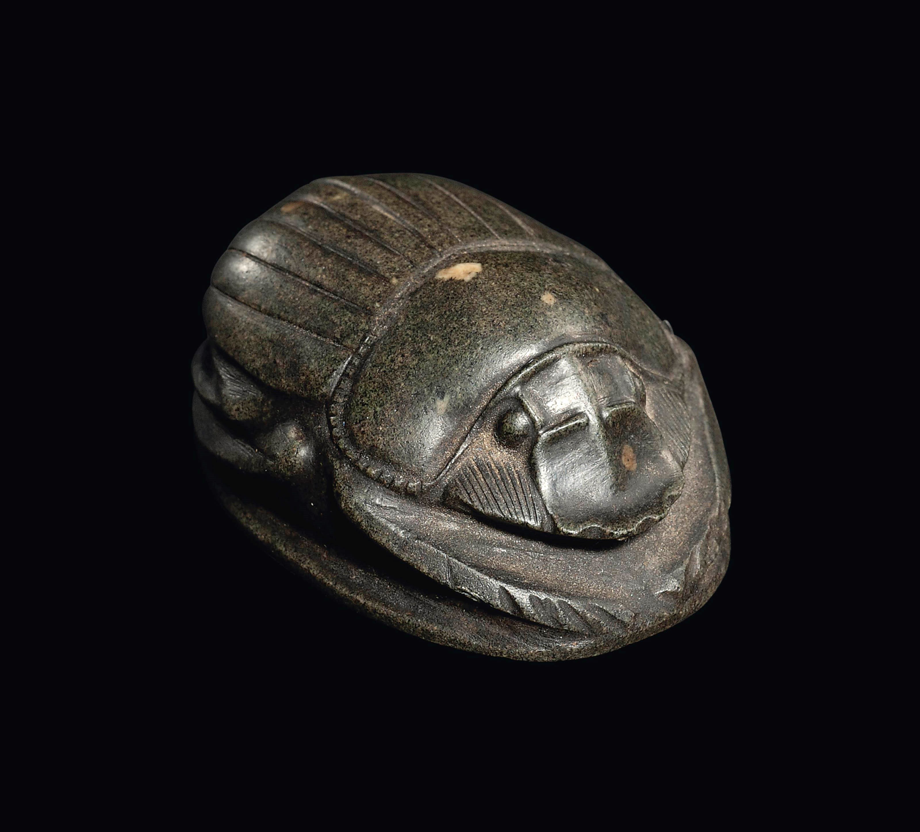 AN EGYPTIAN GREEN SCHIST HEART SCARAB