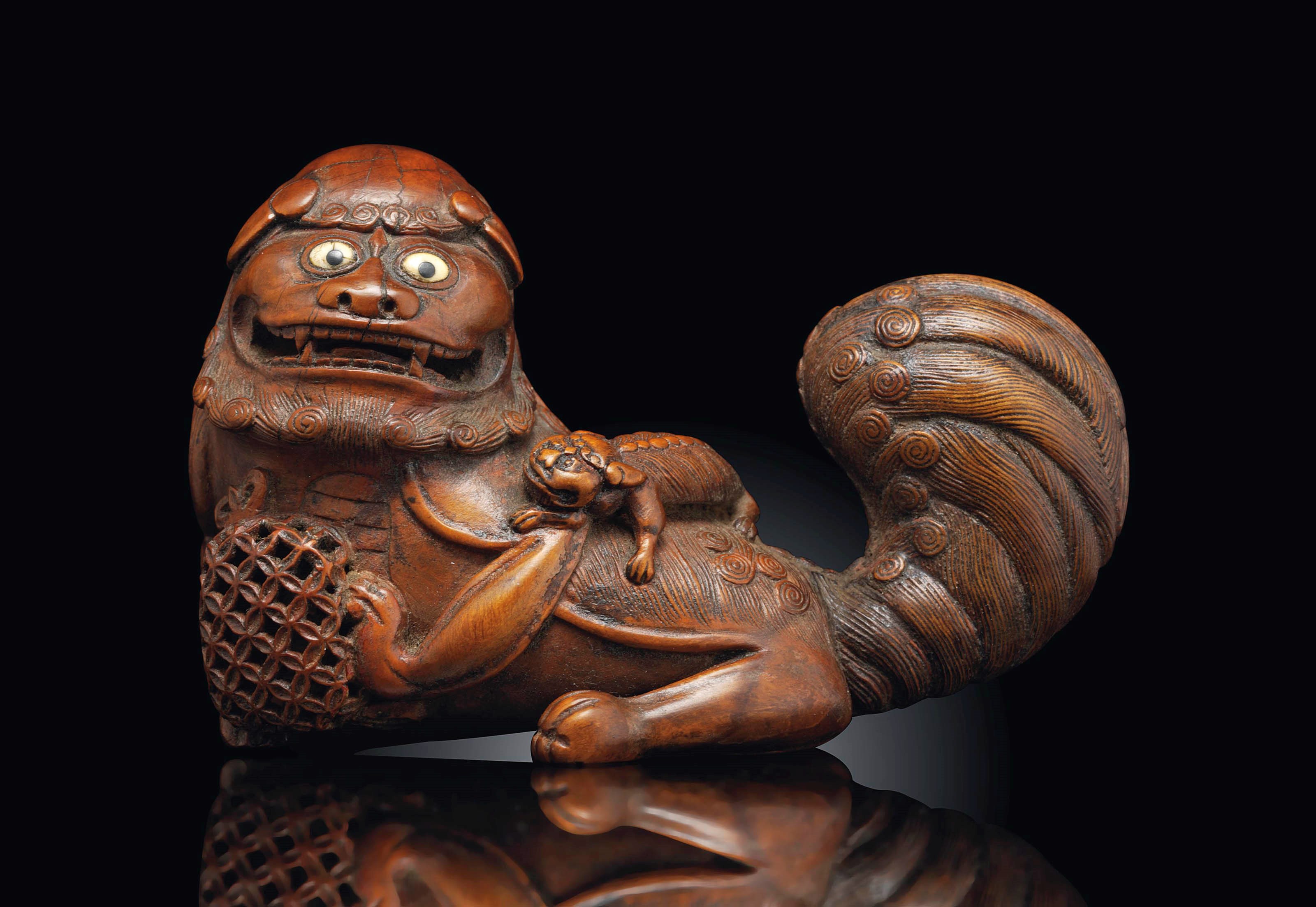 A CARVED WOOD 'BUDDHIST LION' GROUP