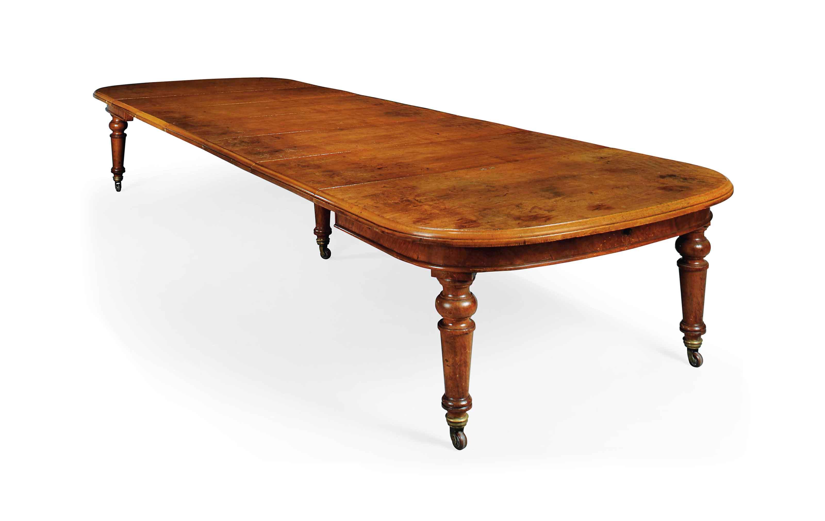 A VICTORIAN OAK EXTENDING DINING TABLE