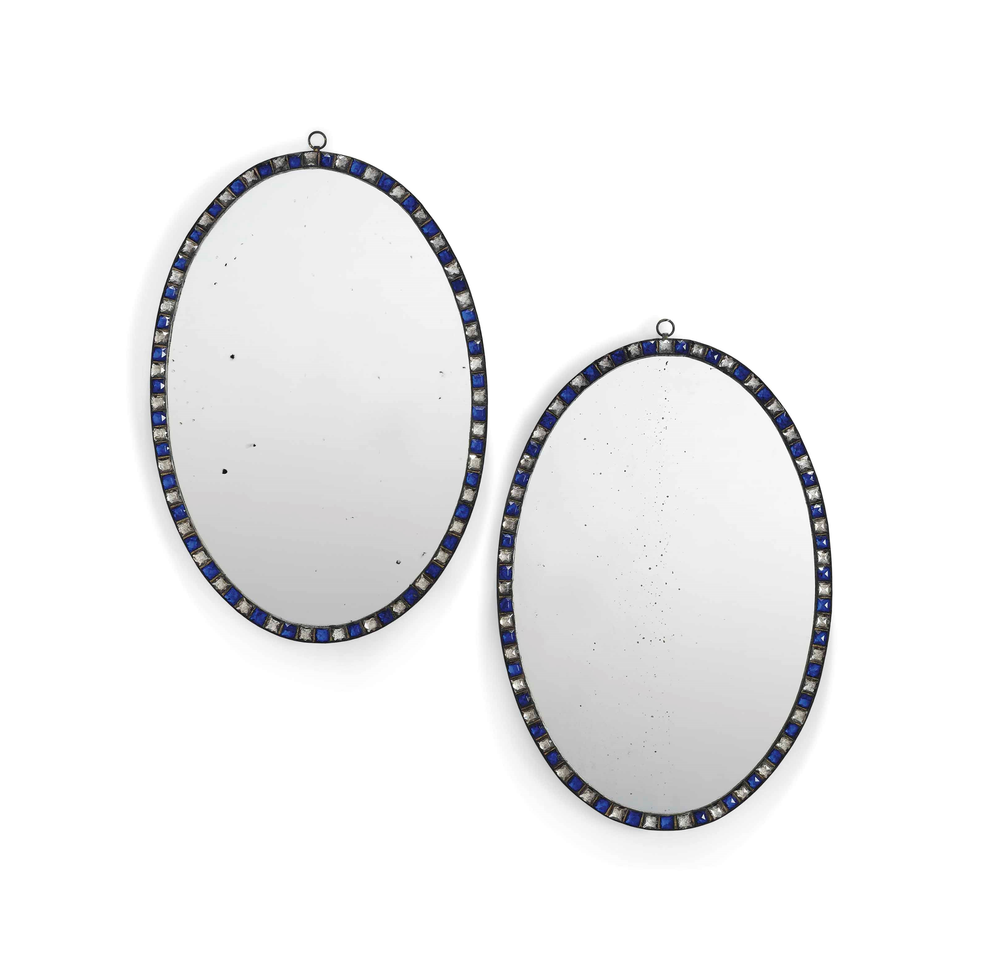 A PAIR OF FACETTED GLASS MOUNTED OVAL MIRRORS