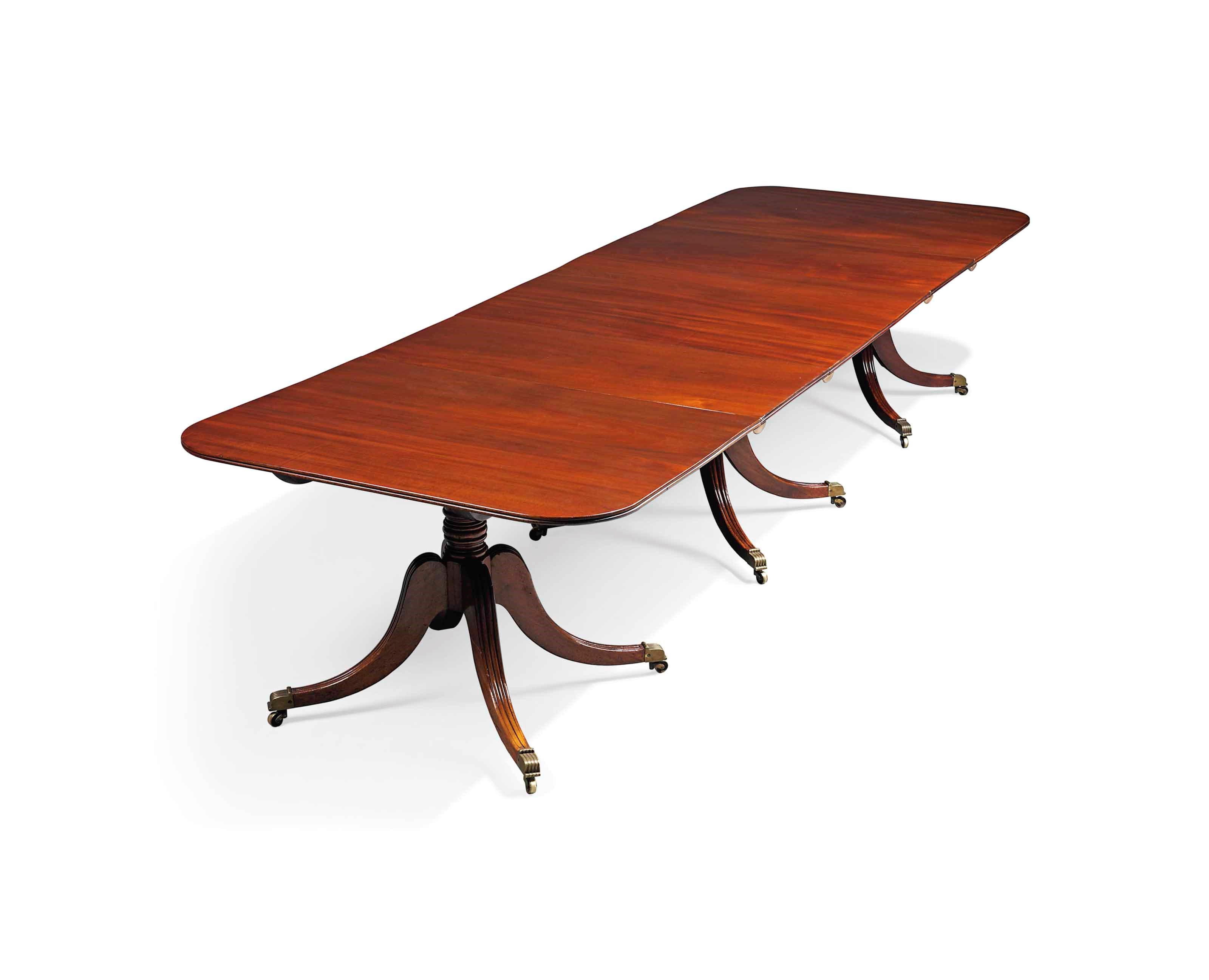 A MAHOGANY TRIPLE PEDESTAL DINING TABLE