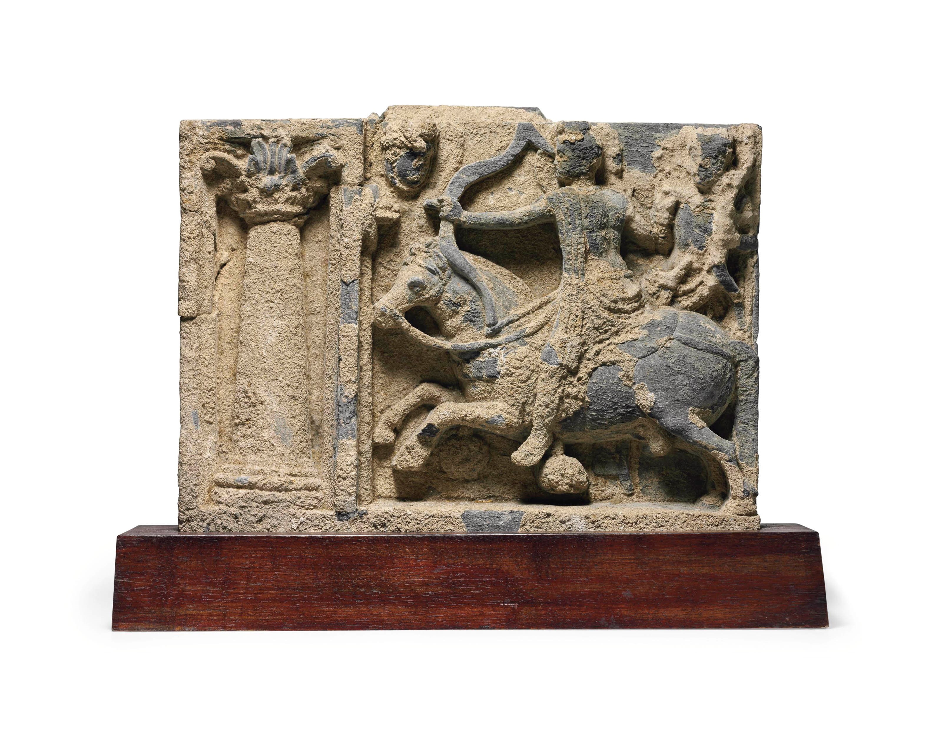 A gray schist relief with the archery contest