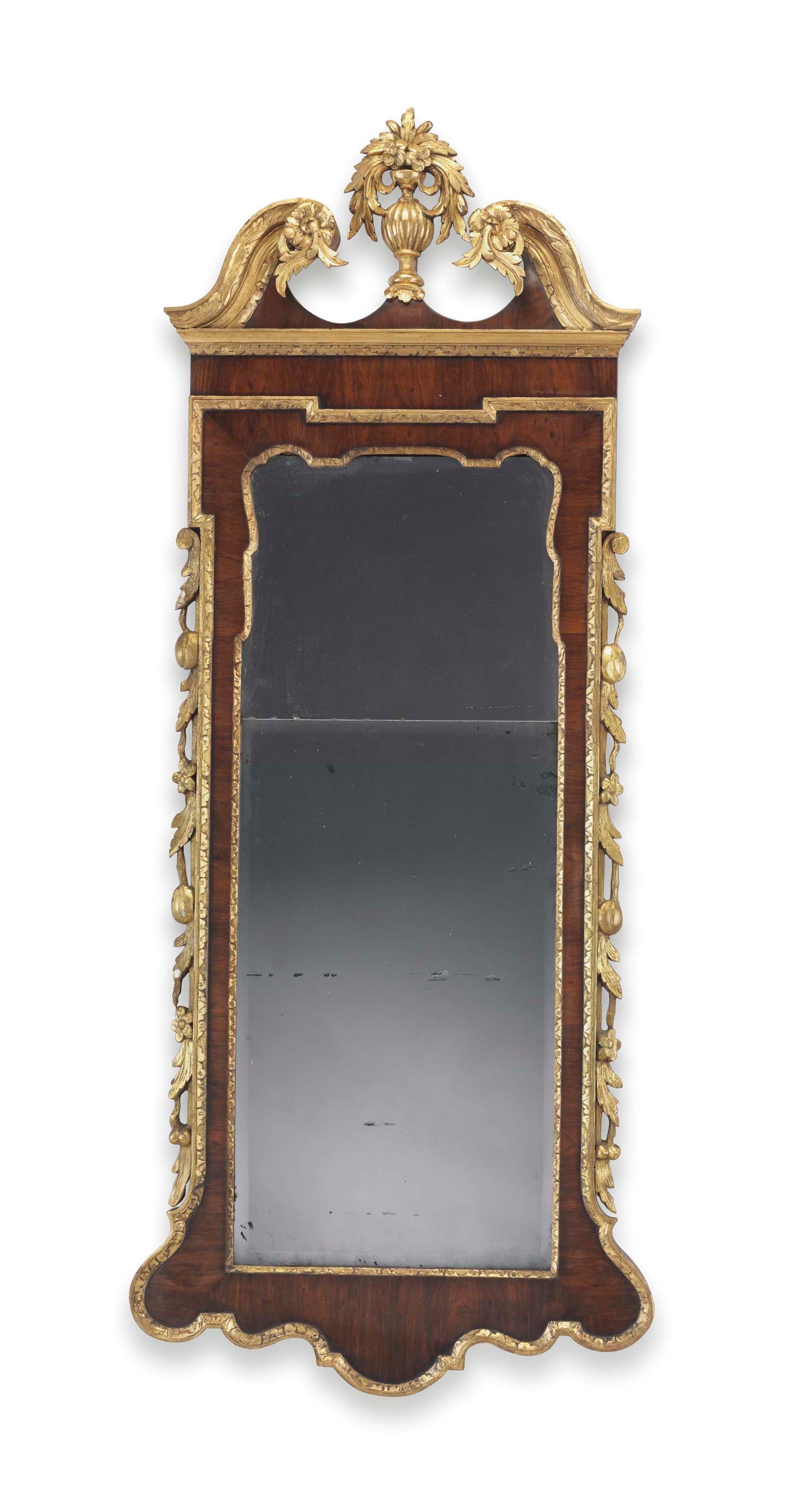 A CHIPPENDALE PARCEL-GILT AND FIGURED MAHOGANY LOOKING GLASS