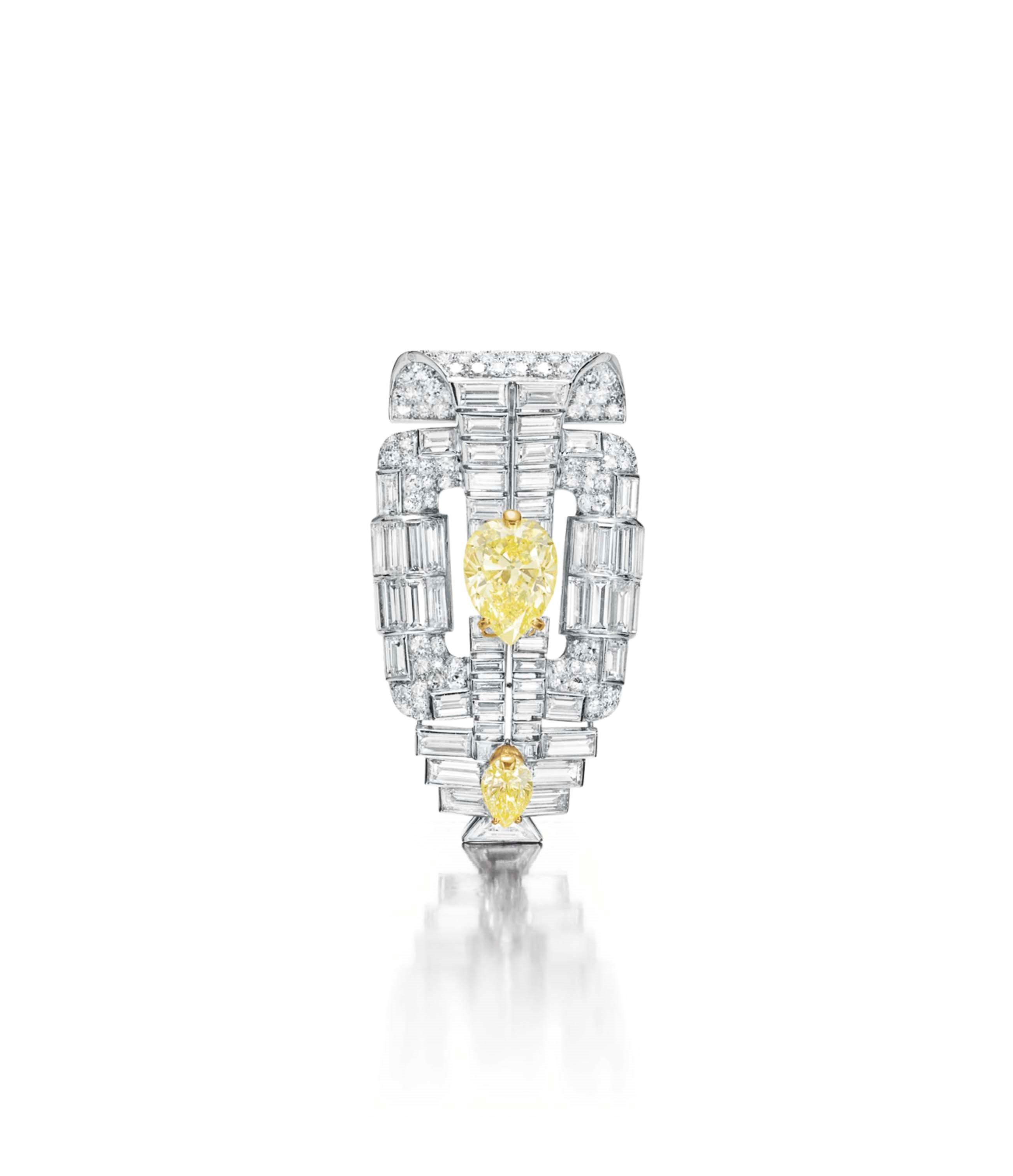 AN ART DECO DIAMOND AND COLORED DIAMOND BROOCH