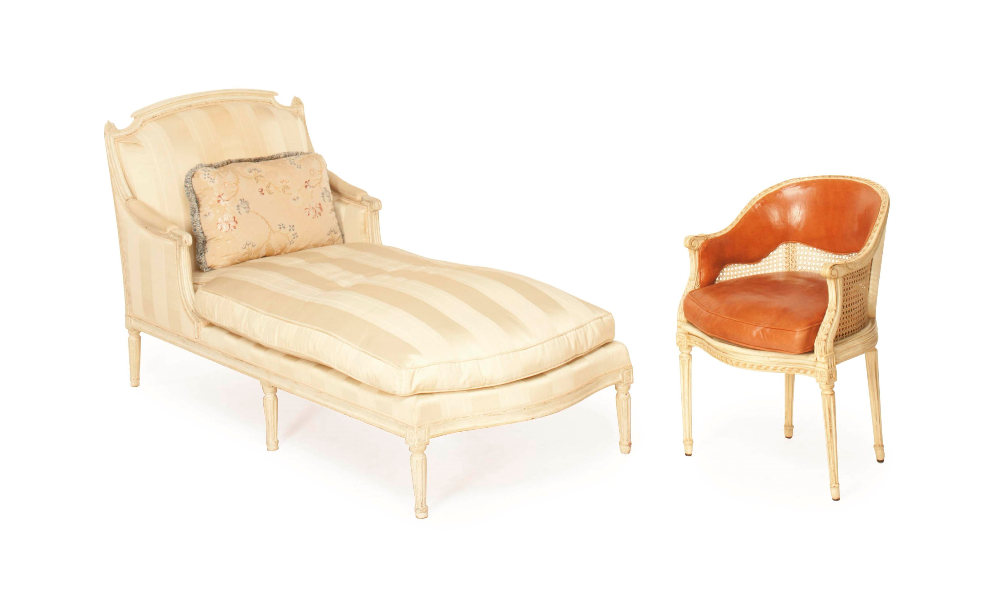 A FRENCH WHITE-PAINTED CHAISE LONGUE AND A CREAM PAINTED AND CANED BERGERE,