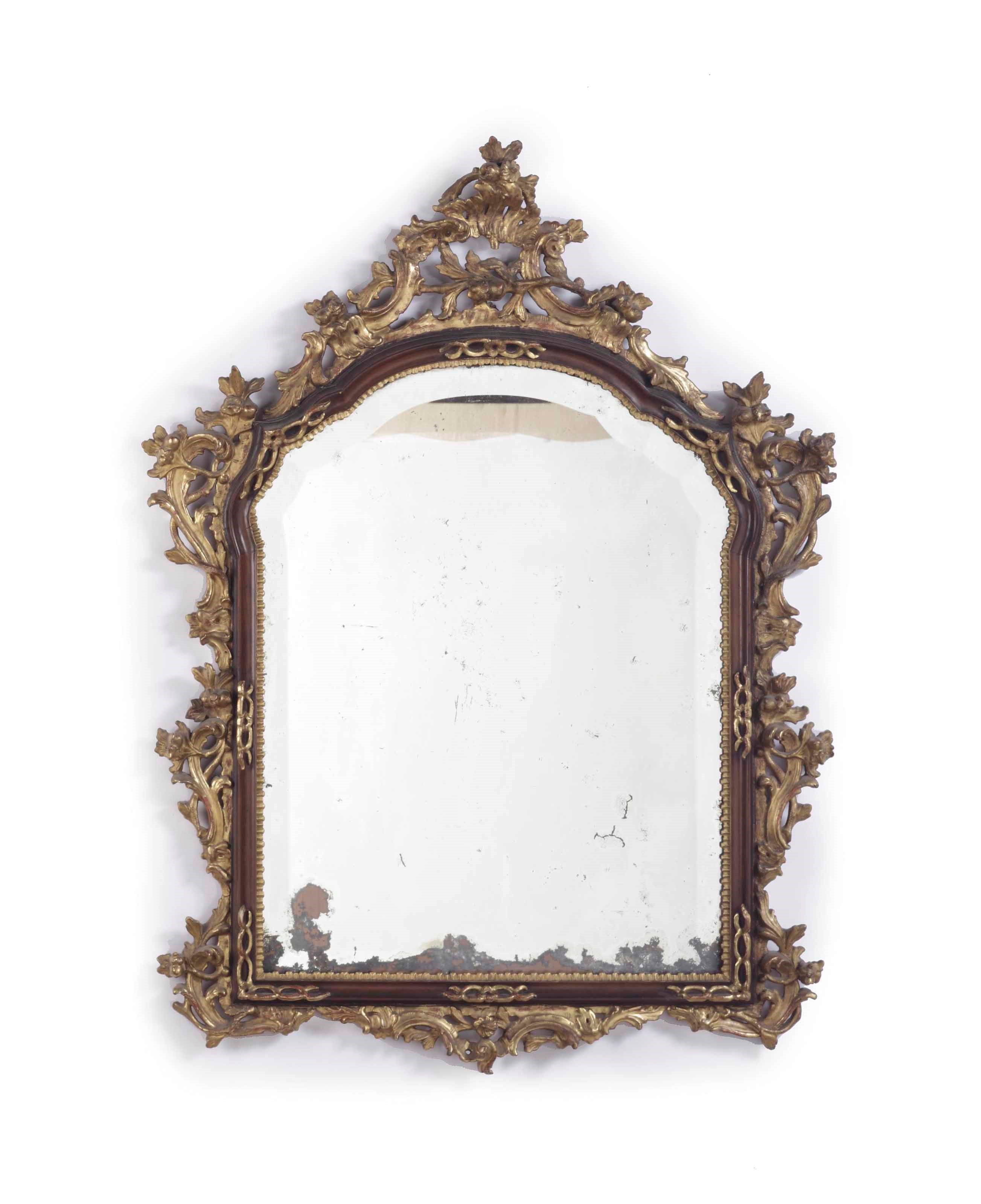 AN AUSTRIAN PARCEL-GILT CARVED WALNUT MIRROR