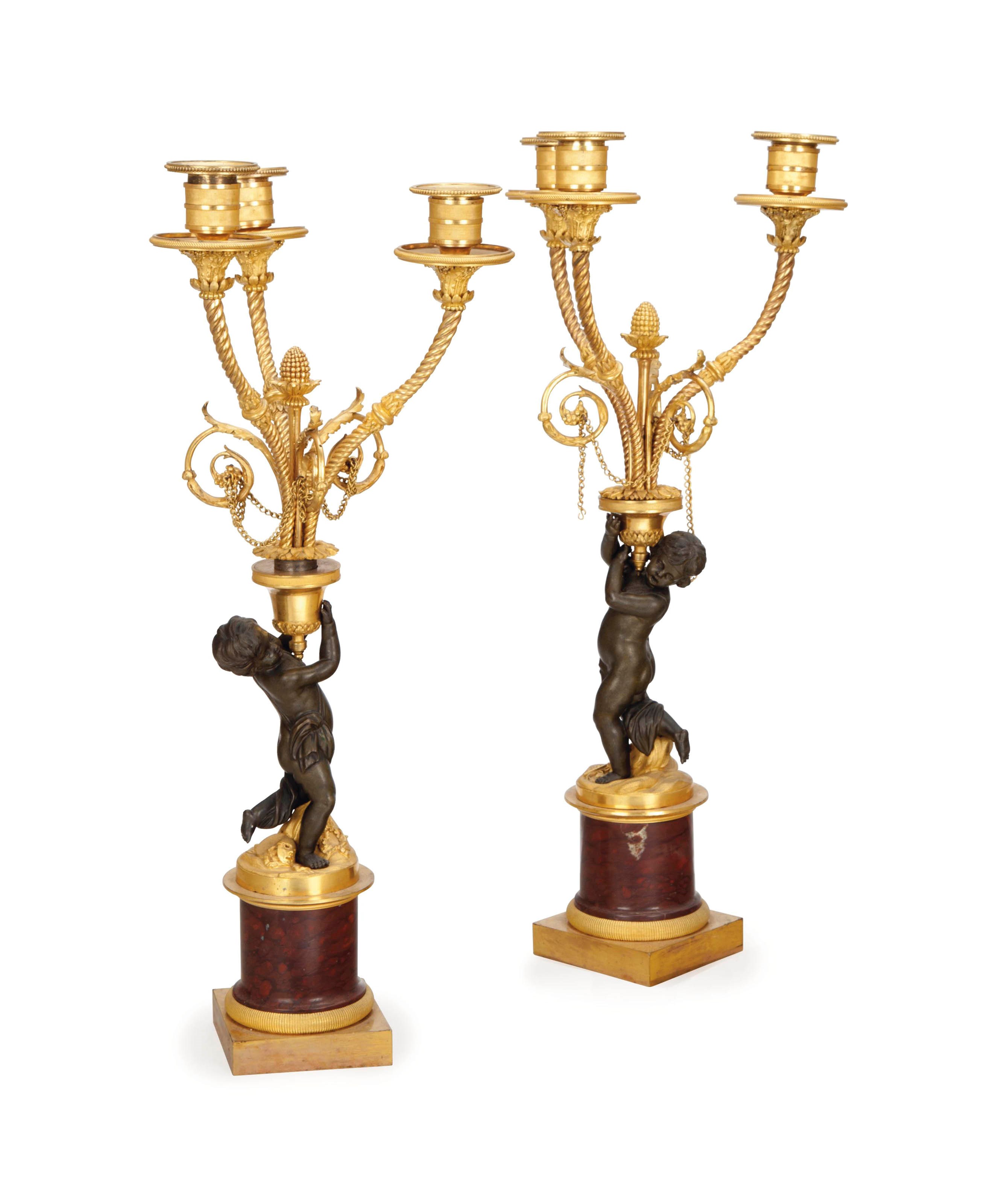 A PAIR OF LOUIS XVI PATINATED, GILT-BRONZE AND RED MARBLE THREE-LIGHT CANDELABRA,