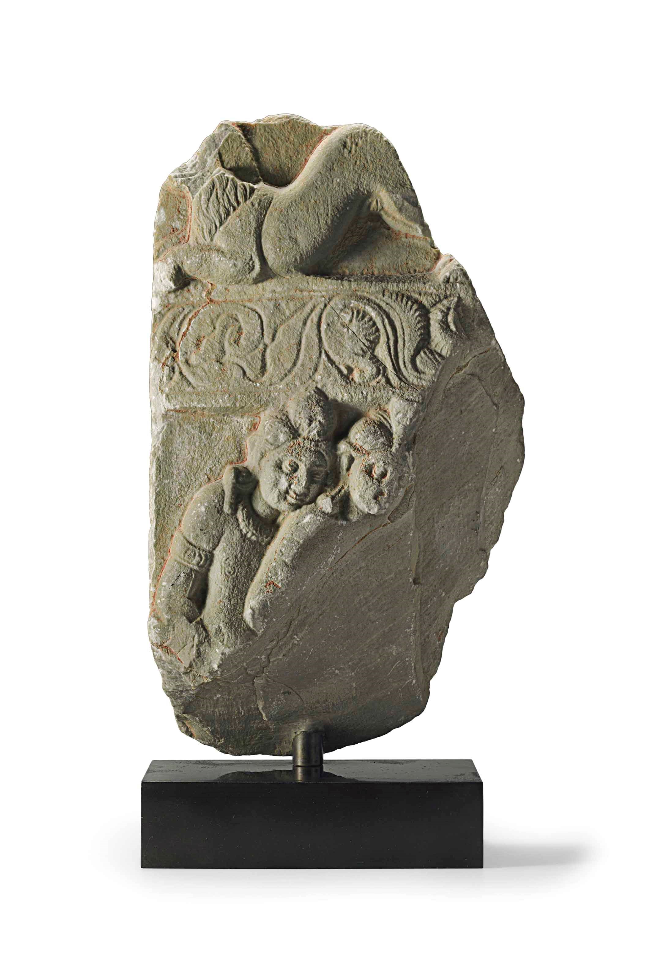 A green limestone relief with two figures