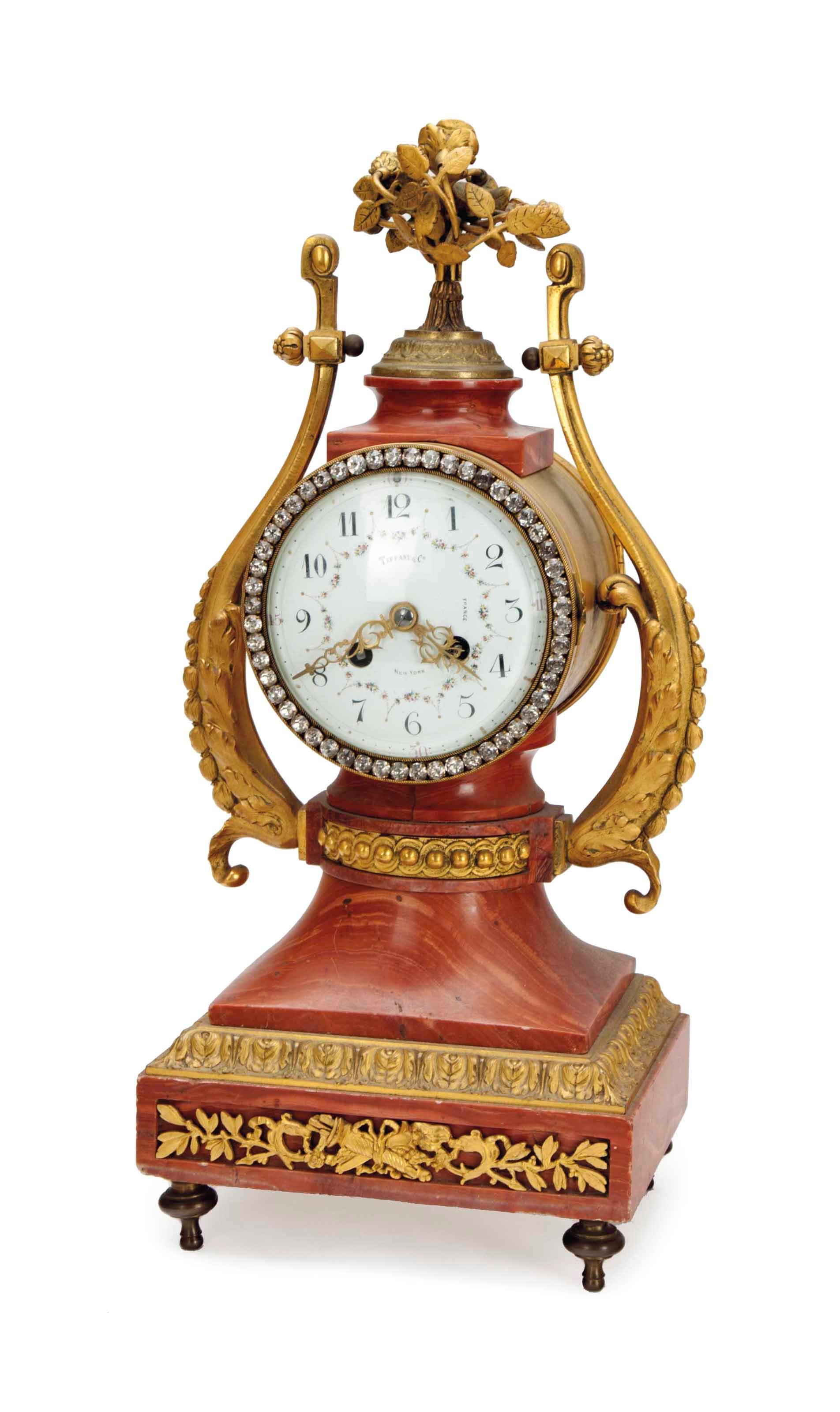 A GILT-BRONZE, ROUGE MARBLE AND JEWELED CLOCK,